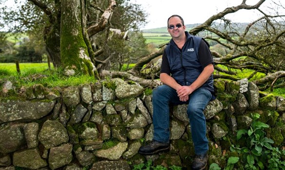Adrian Coombe sat on a dry stone wall
